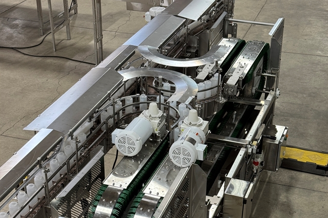 Zoomed out image of inline rinser with plastic bottles